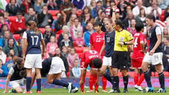 Referee Jenny Palmqvist sends off North Korea's Choe Mi-gyong for a second yellow card offence during their women's football first round Group G match against the U.S. at Old Trafford in Manchester during the London 2012 Olympic Games July 31, 2012.