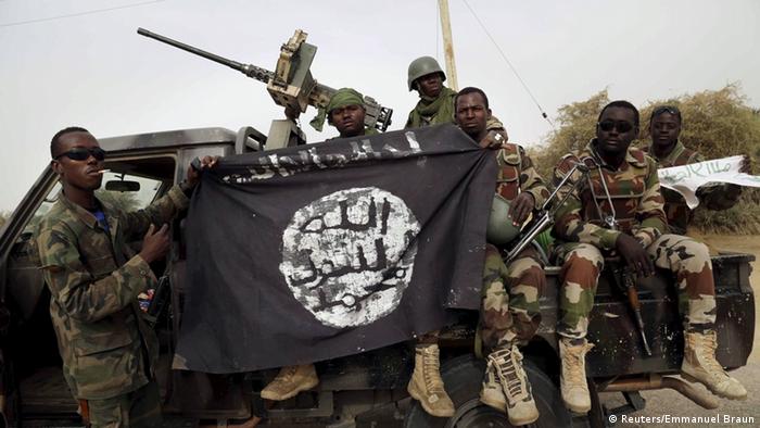 Nigerian soldiers display a captured Boko Haram flag