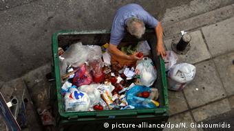 man rummaging through rubbish

AP Photo/Nikolas Giakoumidis)