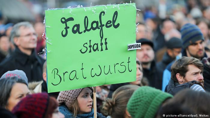 Counter-movement placard at Dresden PEGIDA rally reads: Falafel instead of sausage.