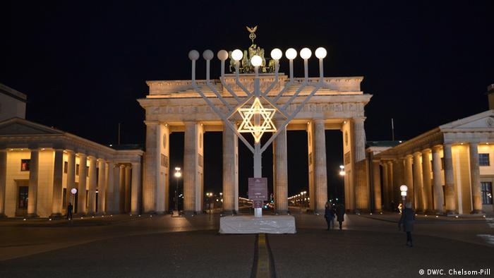 A giant menorah stands in front of Berlin's Brandenburg Gate