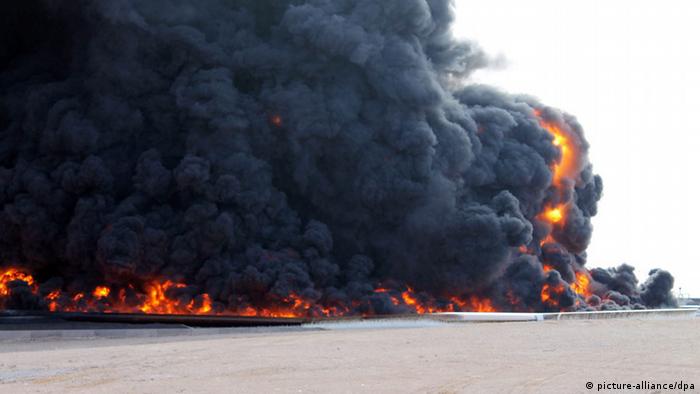 A file picture dated 26 December 2014 shows huge plumes of smoke rising from a large fuel depot fire, al-Sidra, Libya, during fighting. Islamic State militants on 04 January 2016 launched an attack on the port of al-Sidra, Libya's largest oil terminal.
