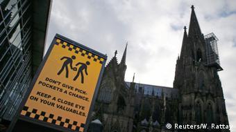 An electronic information sign warning the general public against pickpockets, is displayed on an advertising board outside the main railway station and in front of Cologne Cathedral in Cologne, Germany, January 5, 2016. 