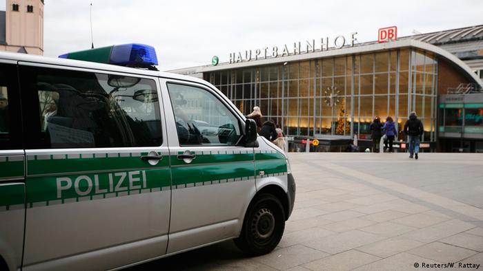 A police vehicle patrols at the main square and in front of the central railway station in Cologne, Germany, 