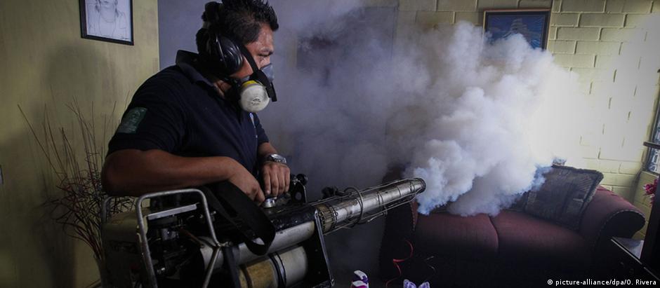 Funcionário do serviço de saúde de El Salvador aplica inseticida contra mosquito transmissor do vírus