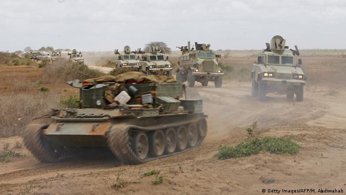 A convoy of African Union Mission in Somalia (AMISOM) armored vehicles passes through the KM50 airstrip on their way to the town of Marka