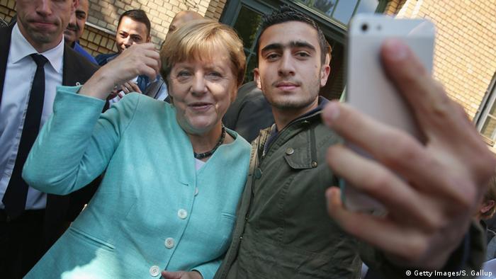 Syrian refugee Modamani makes a selfie with Chancellor Merkel