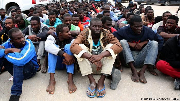 A group of African refugees sitting on the ground