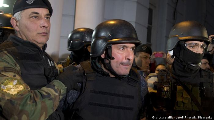 Former Public Works Secretary Jose Lopez in a bullet-proof vest, accompanied by police