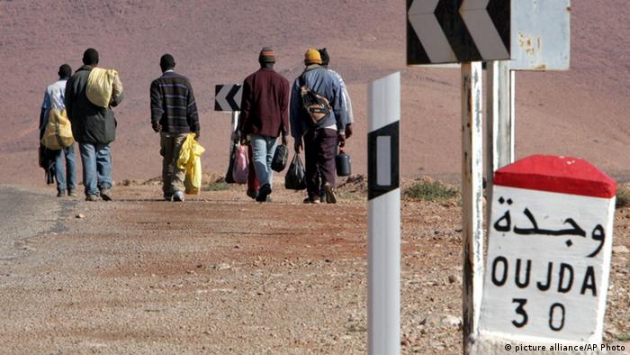 A group of sub-Saharan migrants make their way on foot to the Moroccan town of Oujda