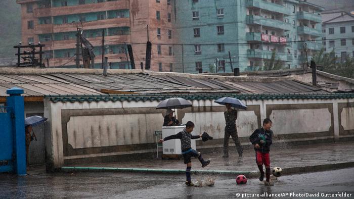 Boys playing soccer in North Korea