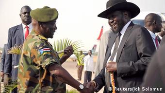 Former army chief Paul Malong shaking hands with President Salva Kiir in 2015 