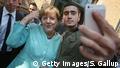 selfie Merkel and refugee Anas Modamani (Getty Images/S. Gallup)