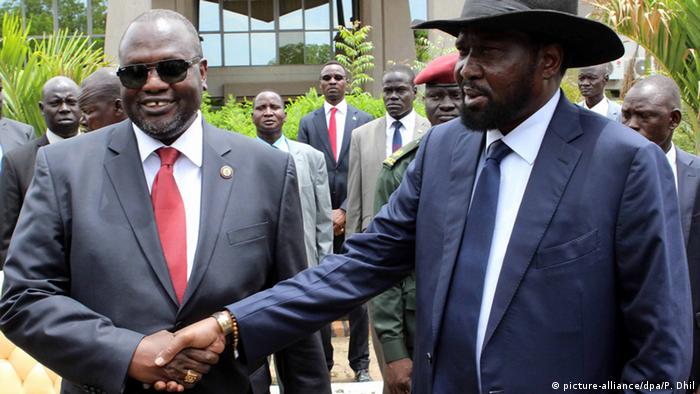South Sudan's President Salva Kiir shaking hands with Riek Machar