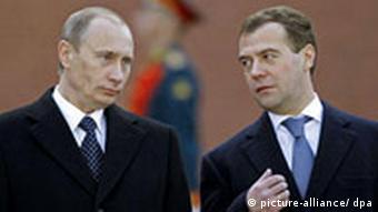 Russian President Dmitry Medvedev speaks with his predecessor Vladimir Putin