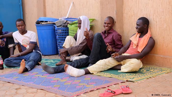 African refugees in Niger sit on the floor waiting for an opportunity to travel further to Europe