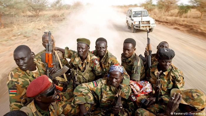 South Sudanese government soldiers sit in the back of a truck (Reuters/G. Tomasevic)