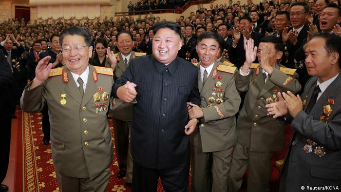 Kim Jong Un flanked by military officials