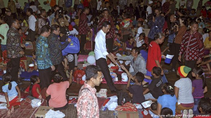Indonesian President Joko Widodo greets villagers at an evacuation center on the island of Bali