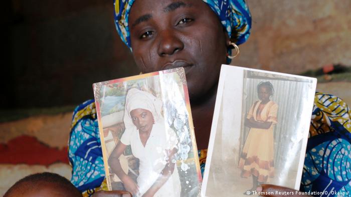 A mother shows photos of her kidnapped daughters (Thomson Reuters Foundation/O. Okakpu)