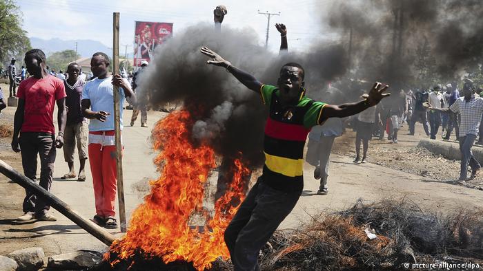 Odinga supporters protesting next to burning tyres