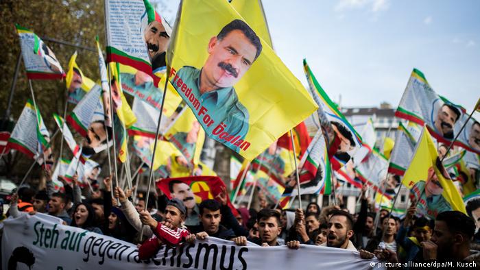 Kurdish protesters march with Ocalan flags in Dusseldorf. 