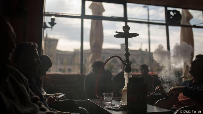Men smoke water pipes in Balgrades Mesopotamia caf