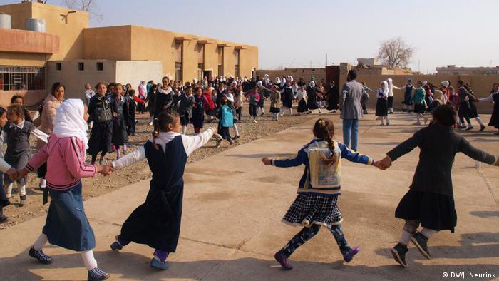 Pupils dancing outside their school in Hawija