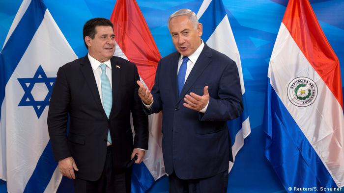 Israeli Prime Minister Benjamin Netanyahu gestures as he stands next to Paraguayan President Horacio Cartes