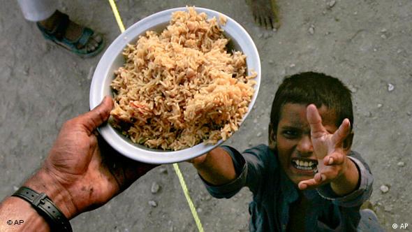A boy receives food at a camp on the outskirt of Sukkur in southern Pakistan
