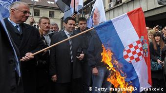 Seselj burning a Croatian flag