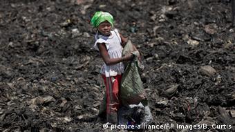Kenyan child collects rubbish in a Nairobi slum