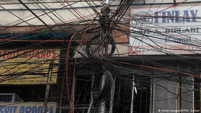 An electric pole is wrapped in a tangle of wires in Kolkata (Photo: Getty Images/AFP/D. Sarkar)
