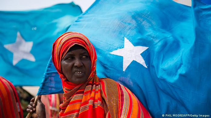 A woman holds the Somali flag (PHIL MOORE/AFP/Getty Images)