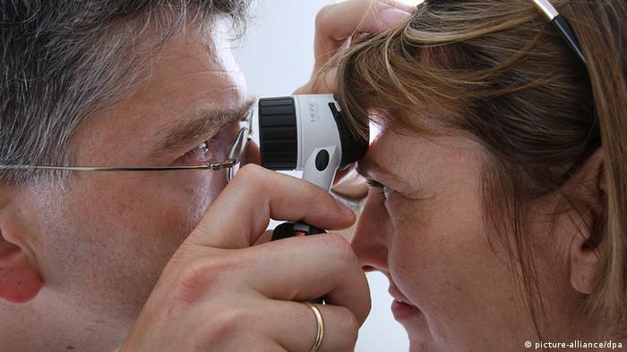 A doctor examines a patient's head