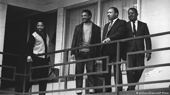 Martin Luther King stands on a balcony with Hosea Williams, Jesse Jackson and Ralph Abernathy