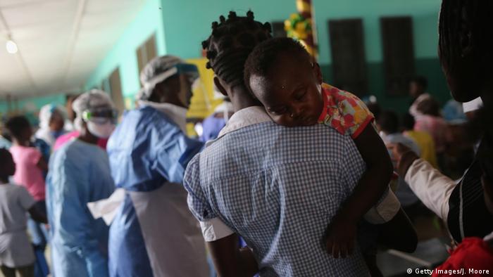 A woman carries her baby inside a hospital in Liberia (Getty Images/J. Moore)