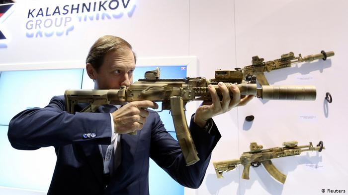 Minister of Industry and Trade of the Russian Federation Denis Manturov holds a machine gun manufactured by the Kalashnikov concern