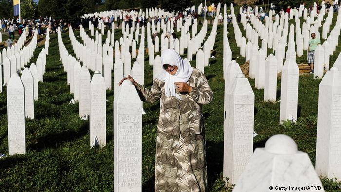 A Bosnian woman mourns at the grave of a relative at Potocari Memorial Center near Srebrenica (Getty Images/AFP/D. Dilkoff)