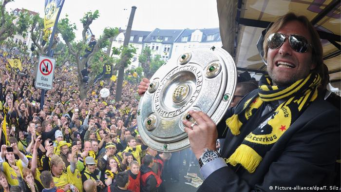 Jürgen Klopp holding the Bundesliga title (Picture-alliance/dpa/T. Silz)
