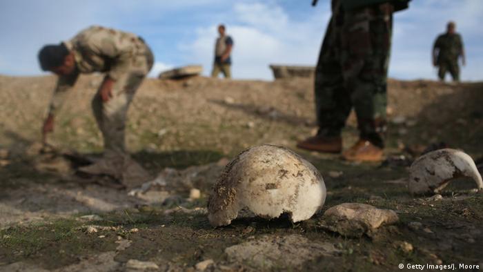 Kurdish Peshmerga show what they say is a mass grave of more than 50 Yazidis killed by ISIL on November 15, 2015 in Sinjar, Iraq. (Getty Images/J. Moore)