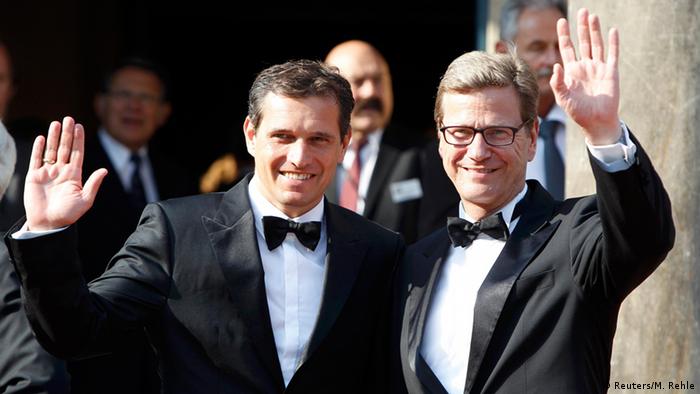 Guido Westerwelle and Michael Mronz waving at camerals at Bayreuth festival in 2012 (Reuters/M. Rehle)