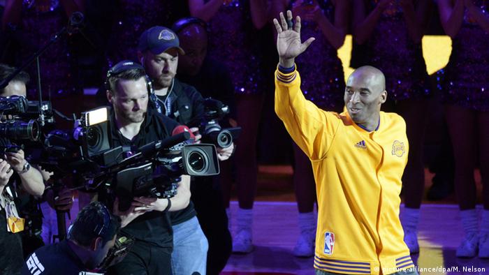 Kobe Bryant waves to fans ahead of his final game