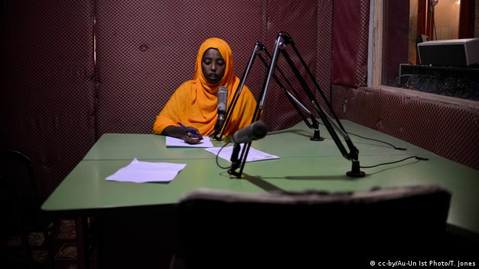 A female presenter reads into a microphone at Radio Shabelle