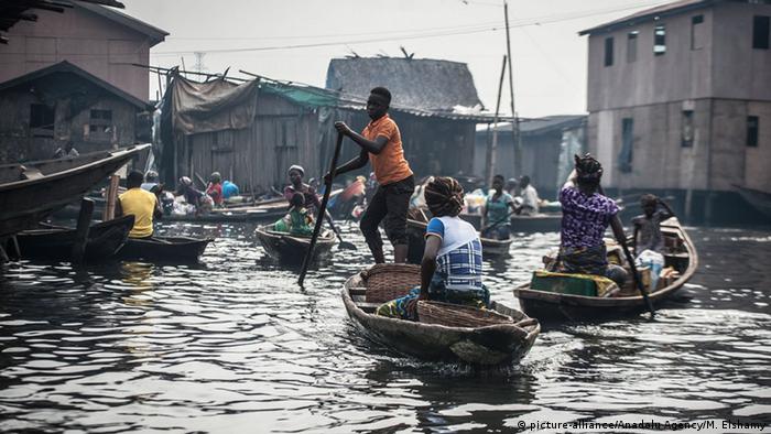 People travel by canoe in the floating slum of Makoko, Nigeria