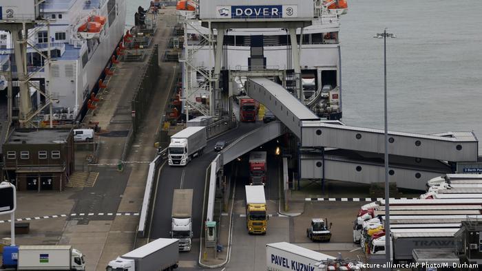 Trucks leave the ferry at the English port of Dover