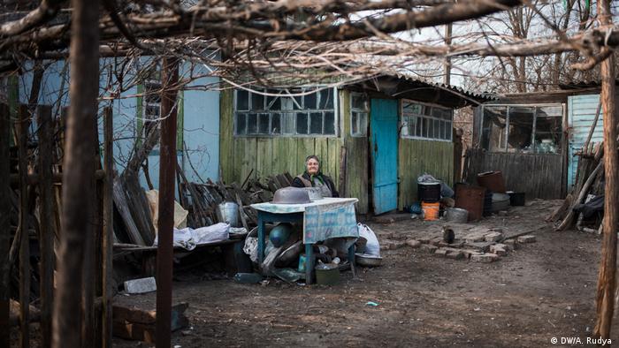 Tetyana Ivanivna sits in front of her house in the village of Teremtsi