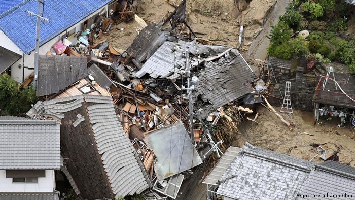 Buildings lie in ruins after being struck by a massive landslide.