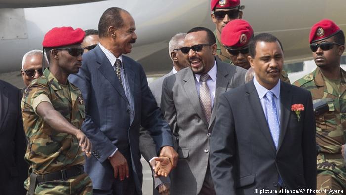 Eritrean President Isaias Afwerki is welcomed by Ethiopia's Prime Minister Abiy Ahmed upon his arrival at Addis Ababa International Airport