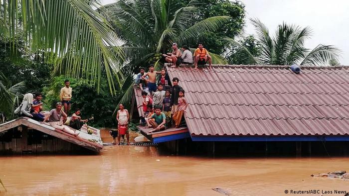 Villagers wait on their rooftops in the aftermath a dambreak in Laos (Reuters/ABC Laos News)